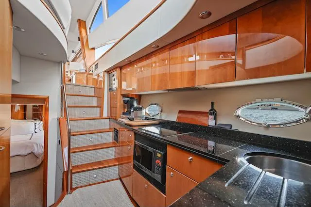 Slide: The Image of Luxurious 2008 Sunseeker Manhattan 60 yacht interior with modern kitchen and elegant wood finishes. - 24