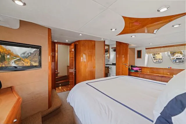 Slide: The Image of Luxurious 2008 Sunseeker Manhattan 60 yacht bedroom with elegant wood finishes and modern amenities. - 29