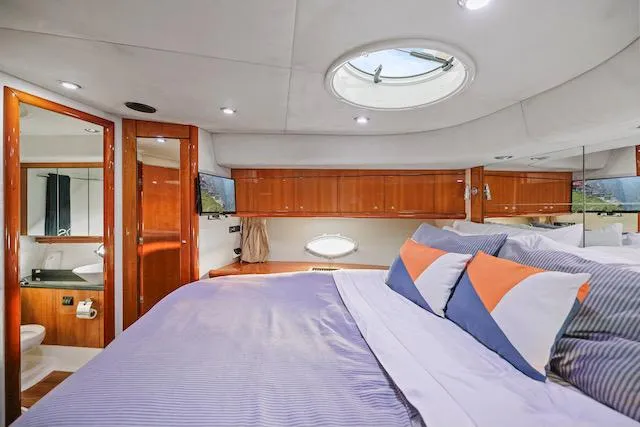 Slide: The Image of Luxurious cabin interior of 2008 Sunseeker Manhattan 60 yacht with elegant bedding and wood finishes. - 34