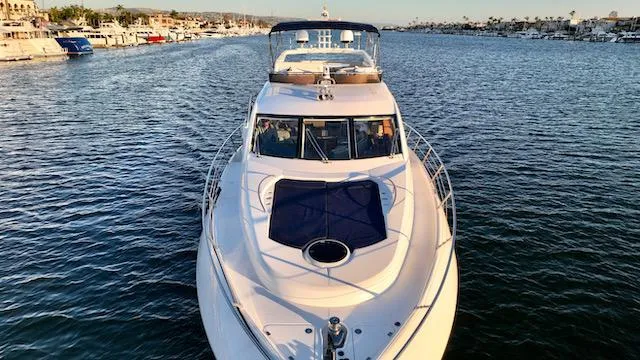 Slide: The Image of 2008 Sunseeker Manhattan 60 yacht cruising on a serene waterway. - 5