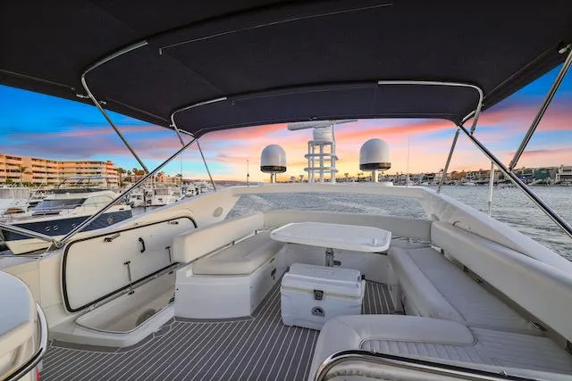 Slide: The Image of Luxurious 2008 Sunseeker Manhattan 60 yacht deck at sunset, featuring elegant seating and modern amenities. - 6