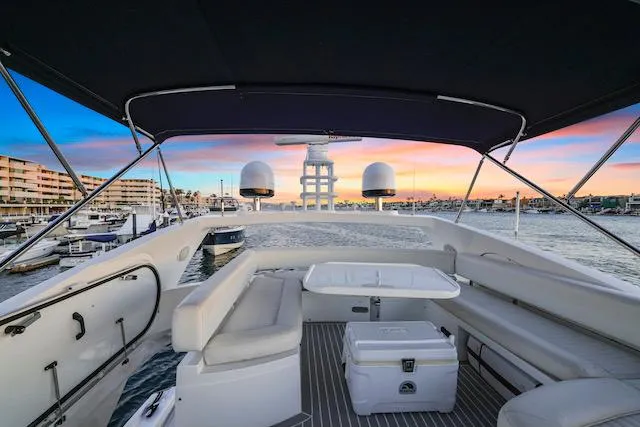 Slide: The Image of Flybridge view of 2008 Sunseeker Manhattan 60 yacht at sunset, featuring seating and ocean backdrop. - 7