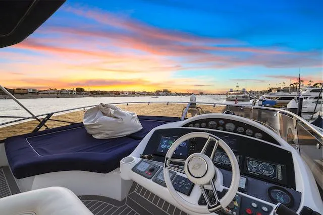 Slide: The Image of Helm of 2008 Sunseeker Manhattan 60 yacht at sunset, featuring luxurious controls and seating. - 8