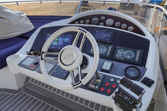 Slide: The Image of Helm of 2008 Sunseeker Manhattan 60 yacht with modern navigation controls and steering wheel. - 9