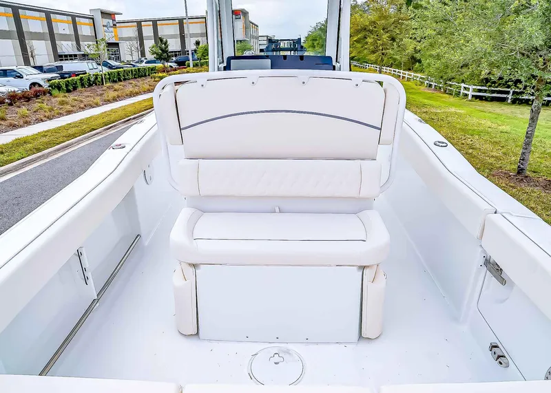 Slide: The Image of 2025 Sea Hunt Ultra 245 SE boat interior with white seating and spacious deck. - 10