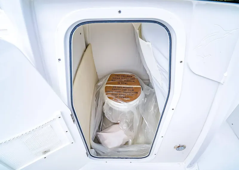 Slide: The Image of Storage compartment in 2025 Sea Hunt Ultra 245 SE boat, featuring protective film and equipment. - 12