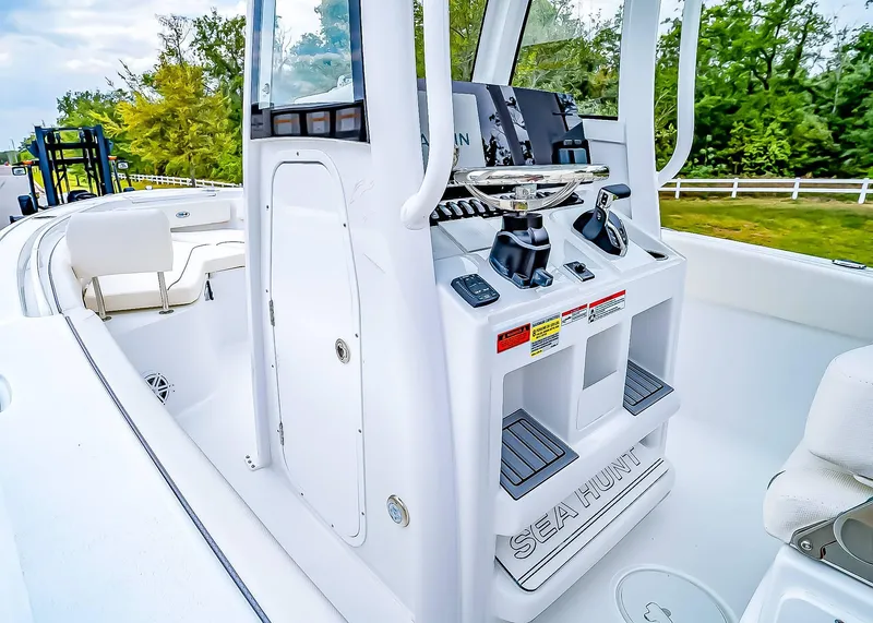 Slide: The Image of 2025 Sea Hunt Ultra 245 SE boat interior with modern console and seating. - 14