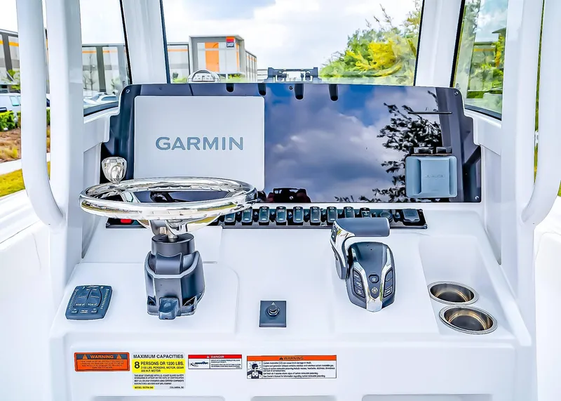 Slide: The Image of 2025 Sea Hunt Ultra 245 SE boat dashboard with Garmin navigation system and controls. - 15