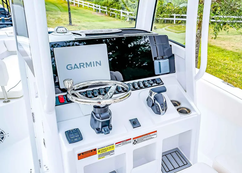 Slide: The Image of 2025 Sea Hunt Ultra 245 SE boat dashboard with Garmin navigation system. - 16