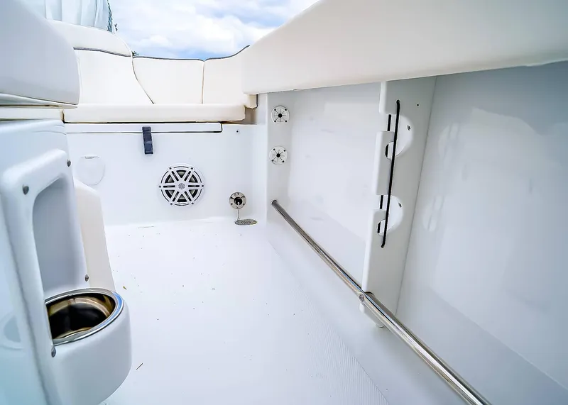 Slide: The Image of 2025 Sea Hunt Ultra 245 SE interior, featuring sleek white seating and modern fixtures. - 20