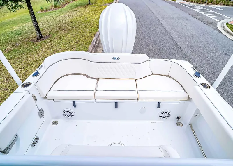 Slide: The Image of 2025 Sea Hunt Ultra 245 SE boat interior with white seating and speakers. - 7