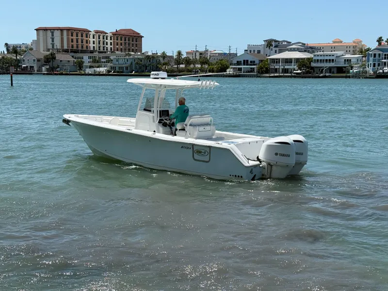 Slide: The Image of 2016 Sea Hunt Gamefish 27 boat cruising on a sunny day near waterfront homes. - 28