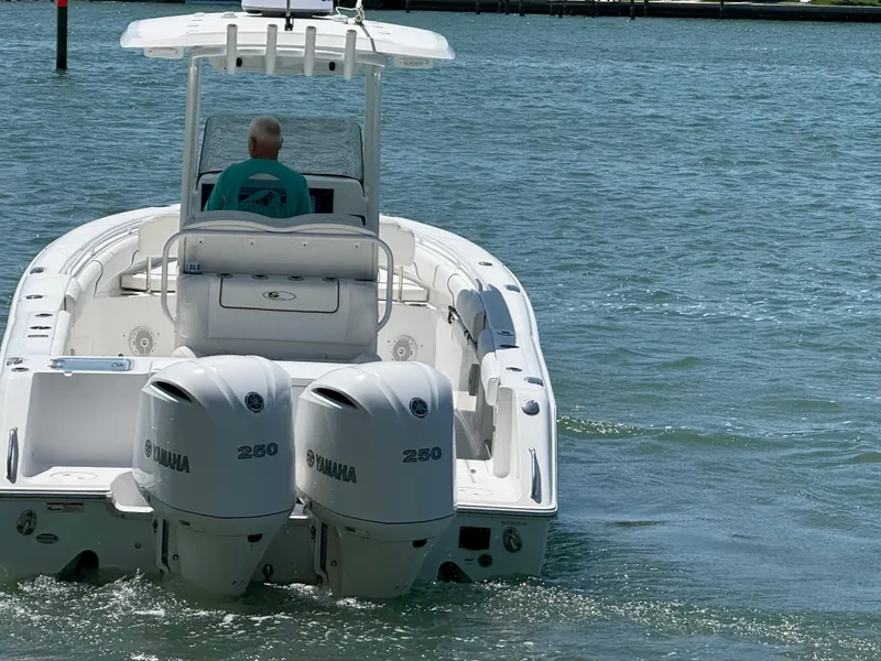 Slide: The Image of 2016 Sea Hunt Gamefish 27 boat with dual Yamaha 250 engines on the water. - 31