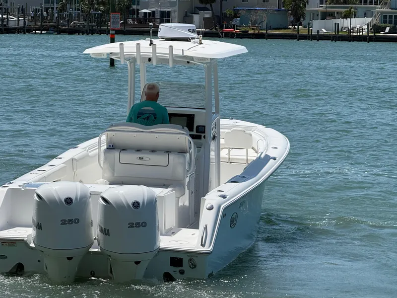Slide: The Image of 2016 Sea Hunt Gamefish 27 boat with dual Yamaha engines on the water. - 32