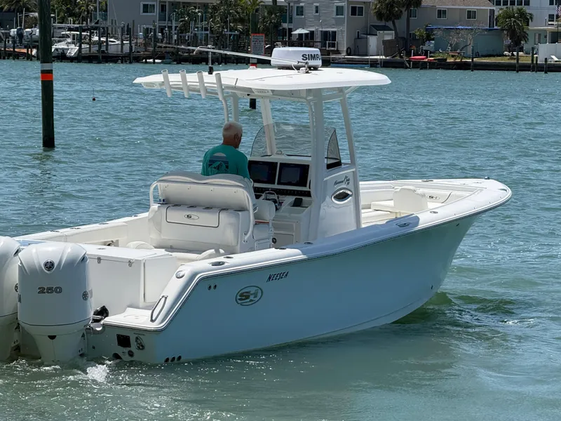 Slide: The Image of 2016 Sea Hunt Gamefish 27 boat cruising on calm water near residential area. - 34