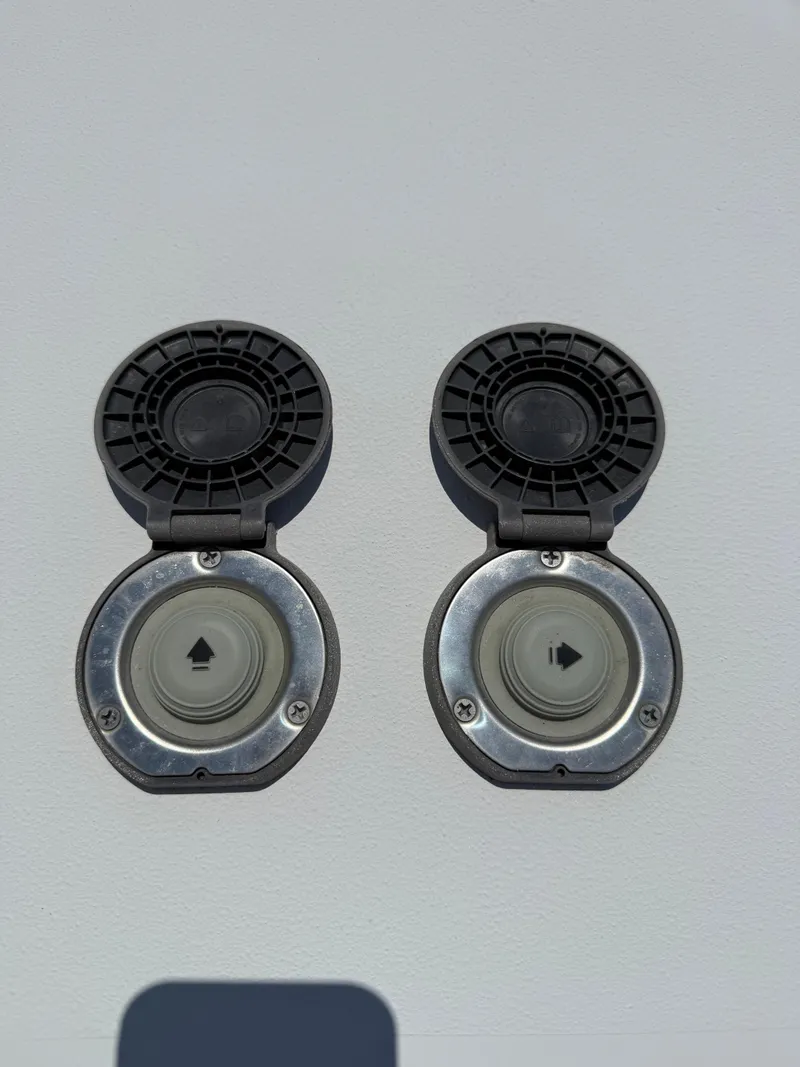 Slide: The Image of 2016 Sea Hunt Gamefish 27 boat fuel caps with open covers. - 39