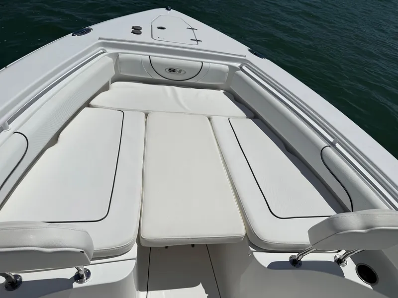 Slide: The Image of 2016 Sea Hunt Gamefish 27 boat interior with white cushioned seating. - 41