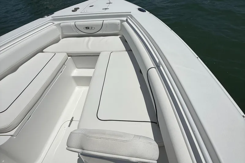 Slide: The Image of 2016 Sea Hunt Gamefish 27 boat interior with white cushioned seating. - 43