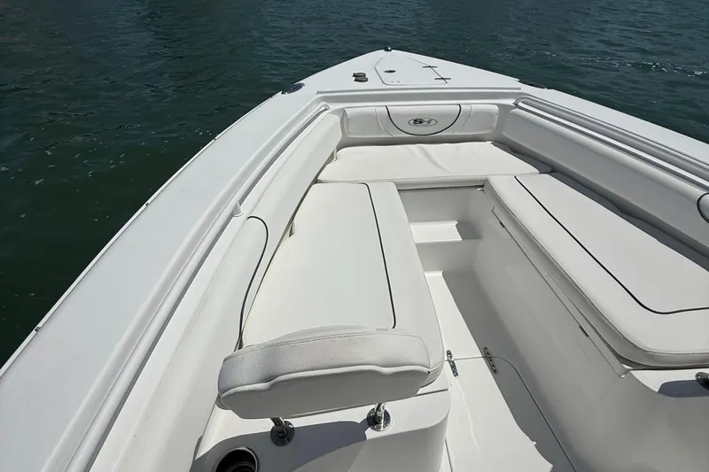 Slide: The Image of 2016 Sea Hunt Gamefish 27 boat interior with white seating and storage compartments. - 44