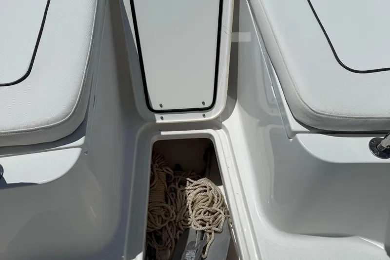 Slide: The Image of 2016 Sea Hunt Gamefish 27 boat storage compartment with rope and anchor. - 48