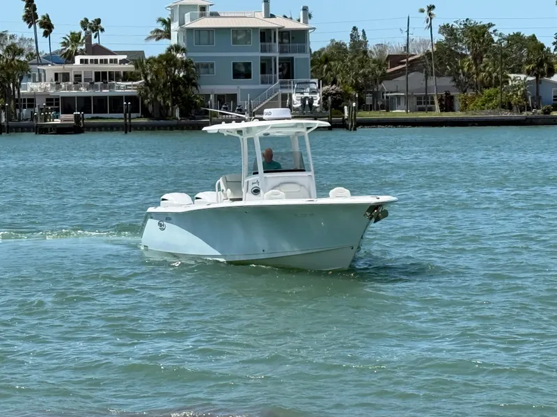 Slide: The Image of 2016 Sea Hunt Gamefish 27 boat cruising on a sunny day near waterfront homes. - 8