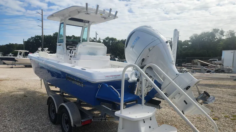 Slide: The Image of 2025 Everglades 253 Center Console boat on trailer, featuring a powerful outboard motor. - 1