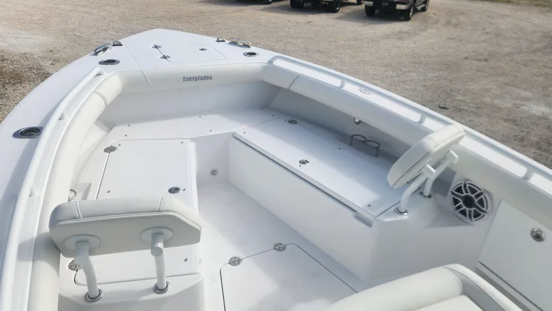 Slide: The Image of 2025 Everglades 253 Center Console boat interior with white seating and steering wheel. - 6