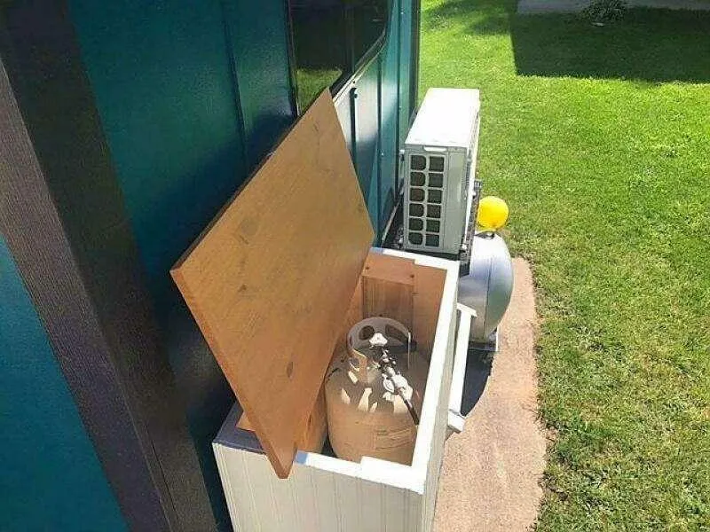 Slide: The Image of Outdoor air conditioning unit with propane tank in wooden enclosure, Custom 25 model, 2023. - 8