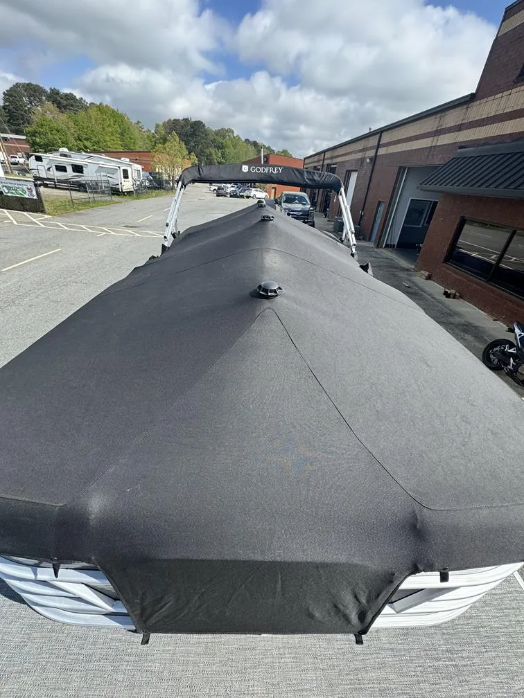 Slide: The Image of 2021 Godfrey Sweetwater 2286 SBX pontoon boat with black cover in parking lot. - 10