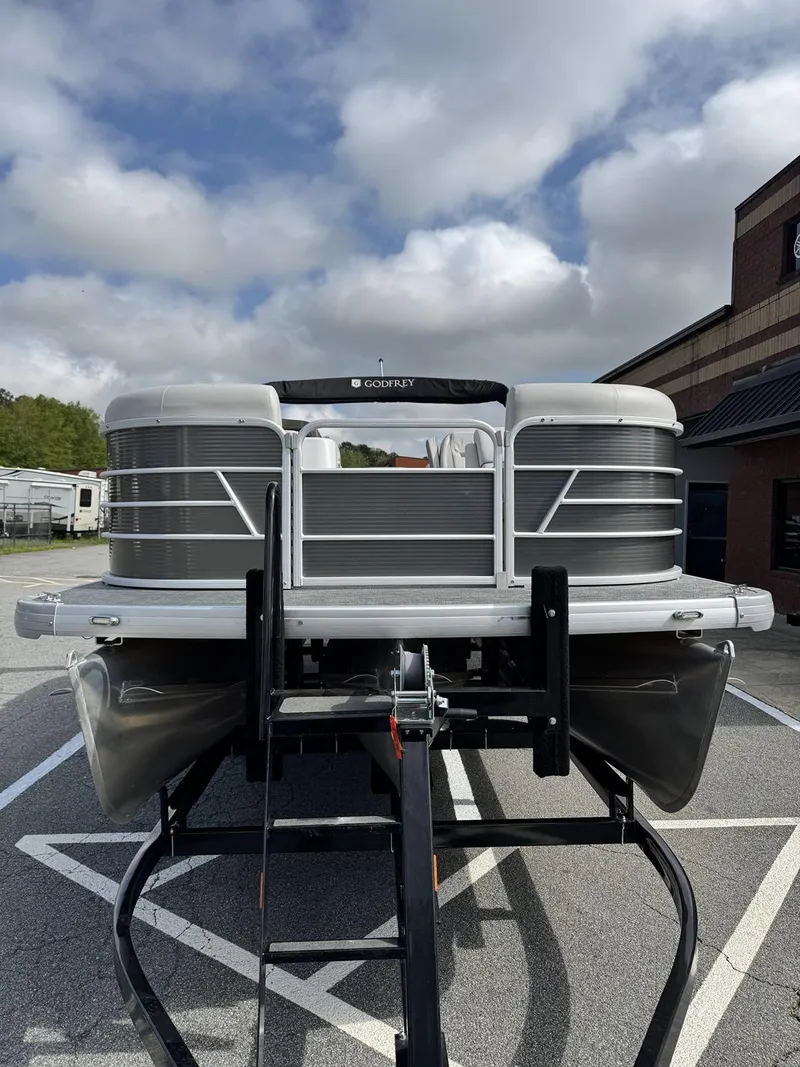 Slide: The Image of 2021 Godfrey Sweetwater 2286 SBX pontoon boat on trailer, parked outdoors. - 3