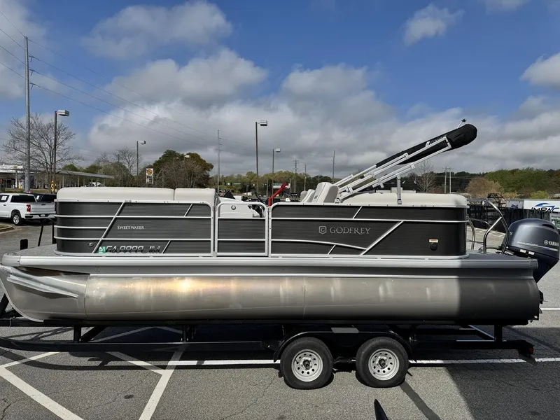 Slide: The Image of 2021 Godfrey Sweetwater 2286 SBX pontoon boat on trailer in parking lot. - 4