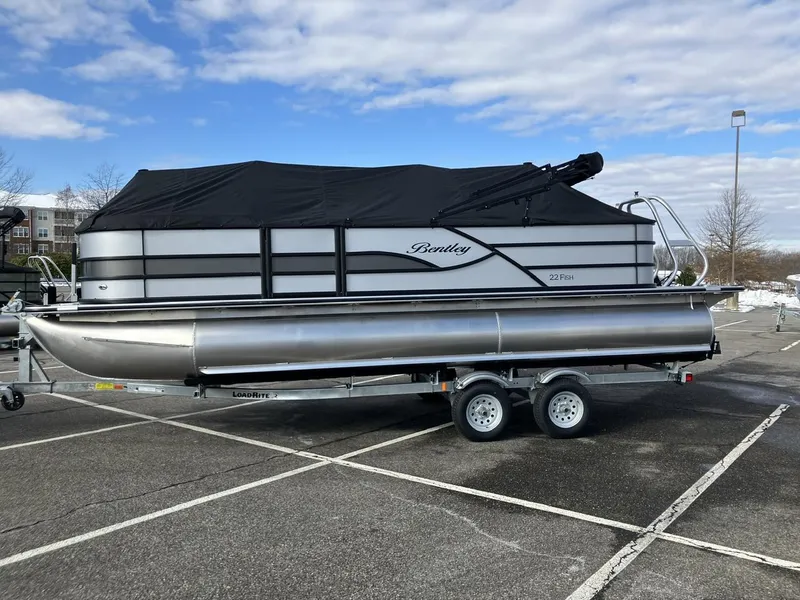 Slide: The Image of 2025 Bentley Pontoons 223 Fish-N-Cruise pontoon boat on trailer in parking lot. - 1