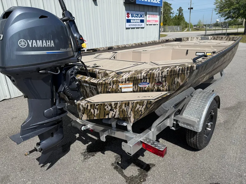 Slide: The Image of Avid 18 Commander 2025 boat with Yamaha engine on trailer, camo design. - 10