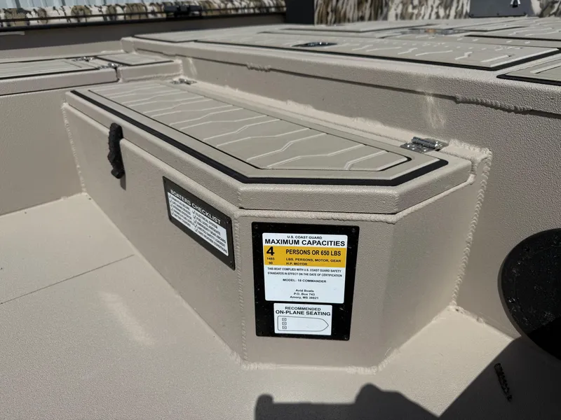 Slide: The Image of 2025 Avid 18 Commander boat storage compartment with capacity label. - 4