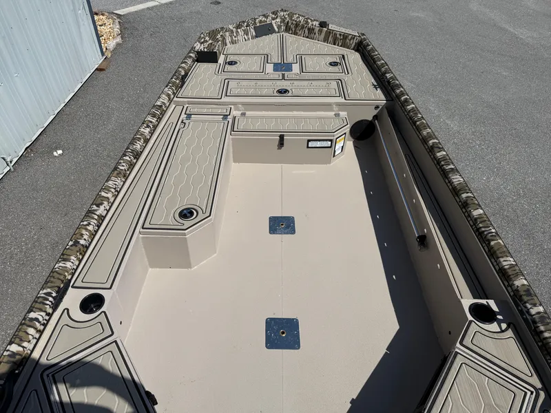 Slide: The Image of 2025 Avid 18 Commander boat interior with storage compartments and camouflage trim. - 5