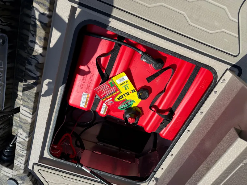 Slide: The Image of Open storage compartment in 2025 Avid 18 Commander boat with red fuel tank. - 8