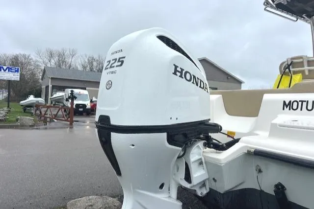 Slide: The Image of 2020 Key West 239 FS boat with Honda 225 VTEC outboard motor in a parking lot. - 1