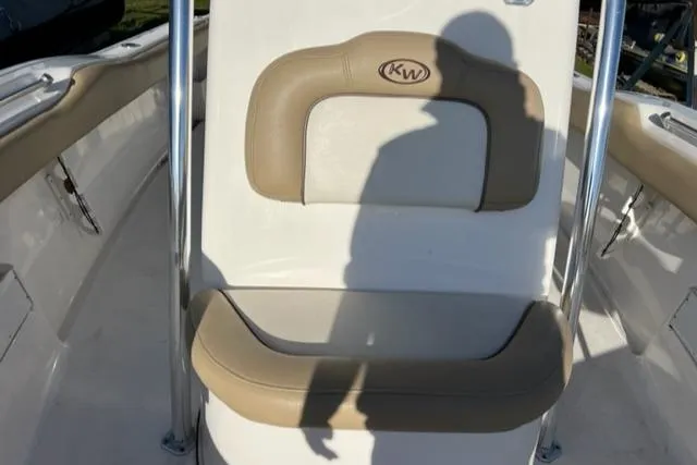 Slide: The Image of 2020 Key West 239 FS boat seat with shadow, featuring beige and white upholstery. - 4