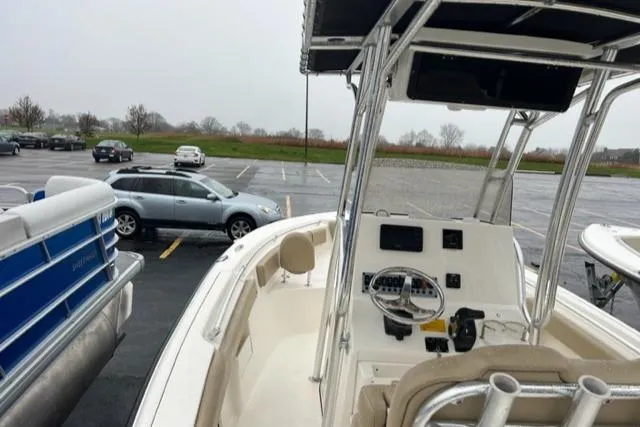 Slide: The Image of 2020 Key West 239 FS boat in parking lot, featuring console and seating. - 9