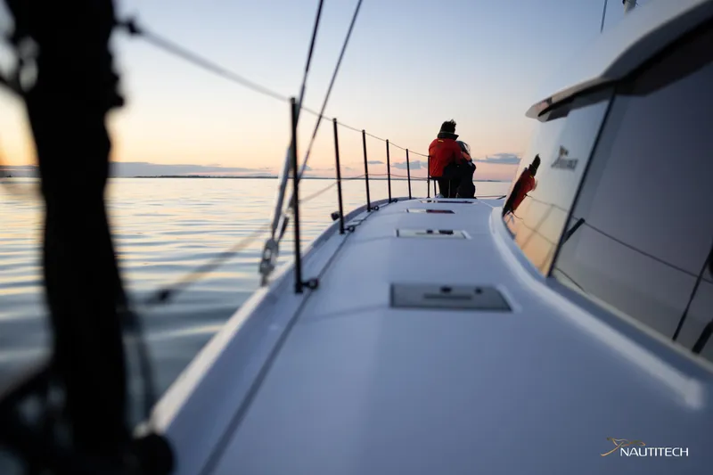 Slide: The Image of 2025 Nautitech 48 Open sailing at sunset with calm waters. - 24