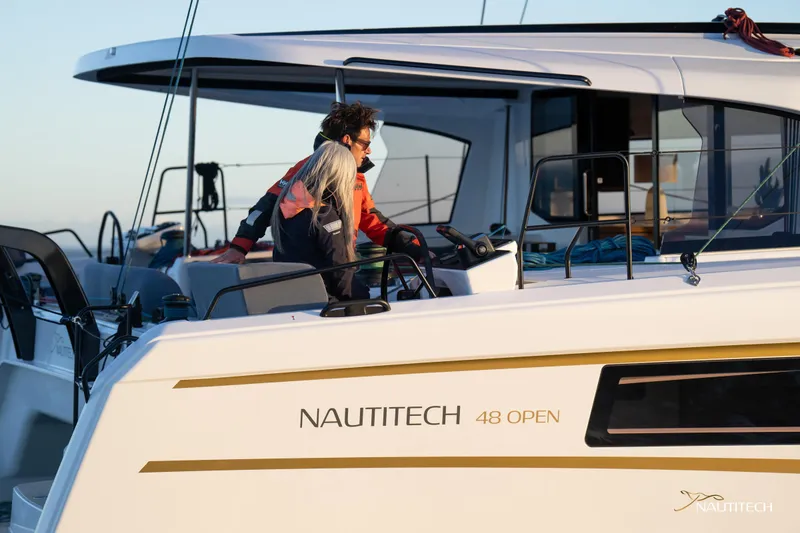 Slide: The Image of 2025 Nautitech 48 Open yacht with people on deck, showcasing modern design and luxury. - 6
