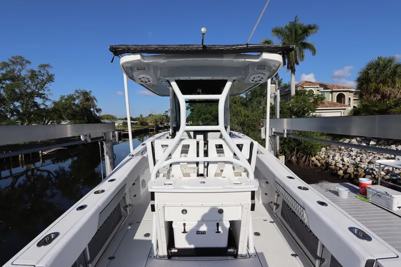 Slide: The Image of 2023 Blackfin 272 CC boat docked, showcasing spacious deck and modern design. - 10