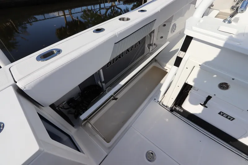 Slide: The Image of 2023 Blackfin 272 CC boat interior with storage compartment and sleek design. - 12