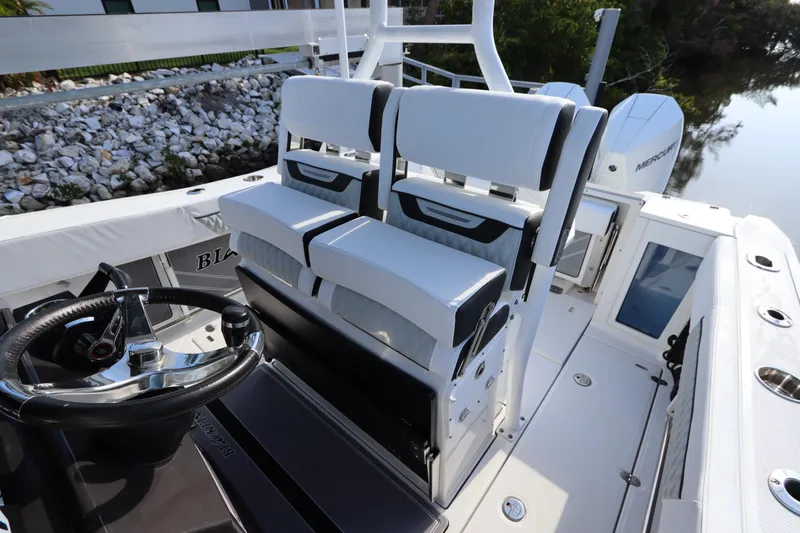Slide: The Image of 2023 Blackfin 272 CC boat interior with dual seating and steering wheel. - 15