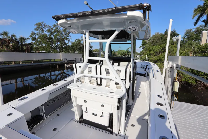 Slide: The Image of 2023 Blackfin 272 CC boat docked, featuring a sleek design and spacious deck. - 16