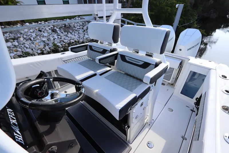 Slide: The Image of 2023 Blackfin 272 CC boat interior with dual helm seats and steering wheel. - 18