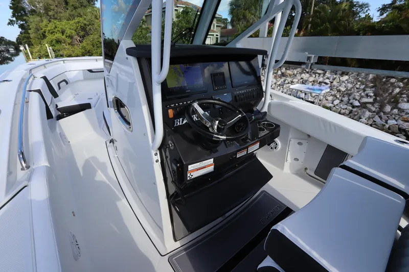 Slide: The Image of 2023 Blackfin 272 CC boat cockpit with modern controls and seating. - 19