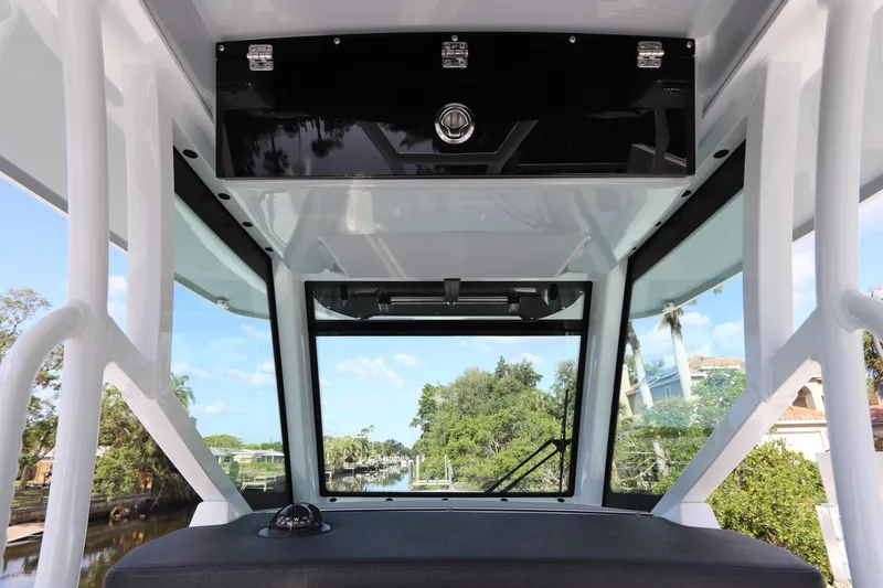 Slide: The Image of 2023 Blackfin 272 CC boat interior with windshield and storage compartment. - 21