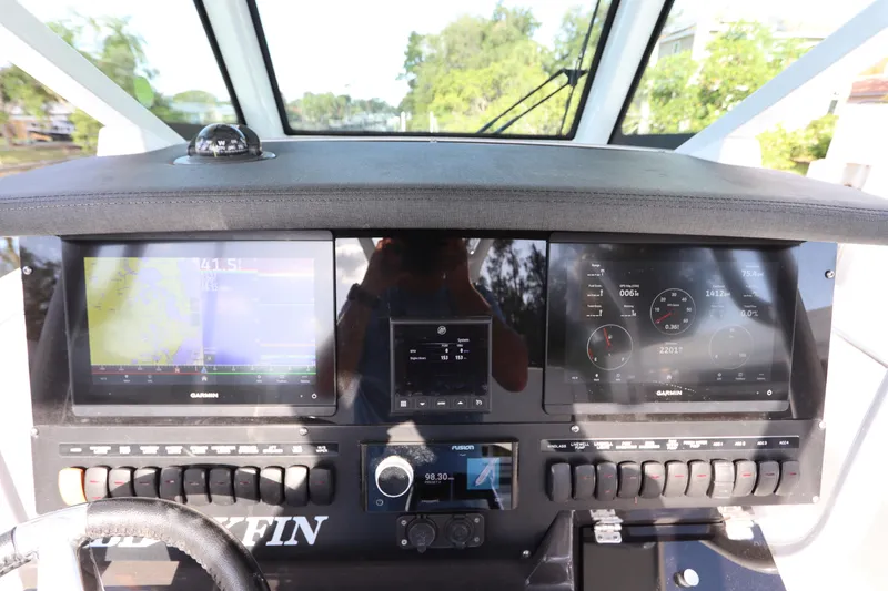 Slide: The Image of 2023 Blackfin 272 CC boat dashboard with dual Garmin displays and control panel. - 22