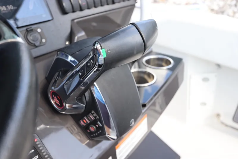 Slide: The Image of Throttle control of 2023 Blackfin 272 CC boat, featuring modern design and dual cup holders. - 27